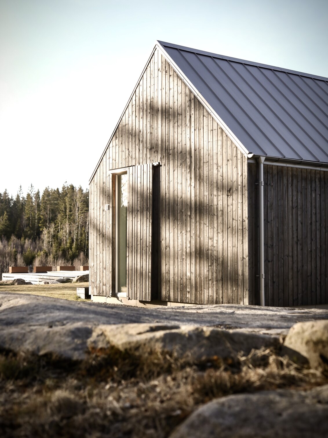 Trähus vid utkanten av en skog.