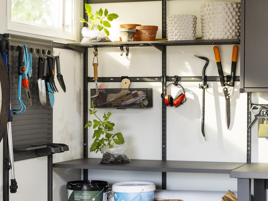 Garage with Garage+ storage from Elfa used to store plants and garden tools.