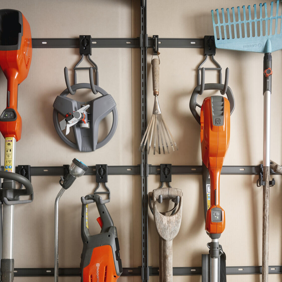 Garage+ storage tracks from Elfa for hanging gardening tools.