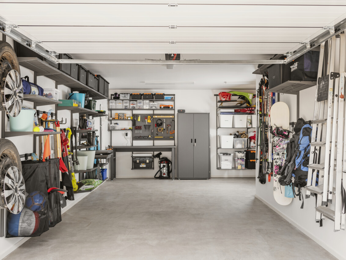 Garage with Garage+ by Elfa storage where tools, garden tools and sports equipment are stored.