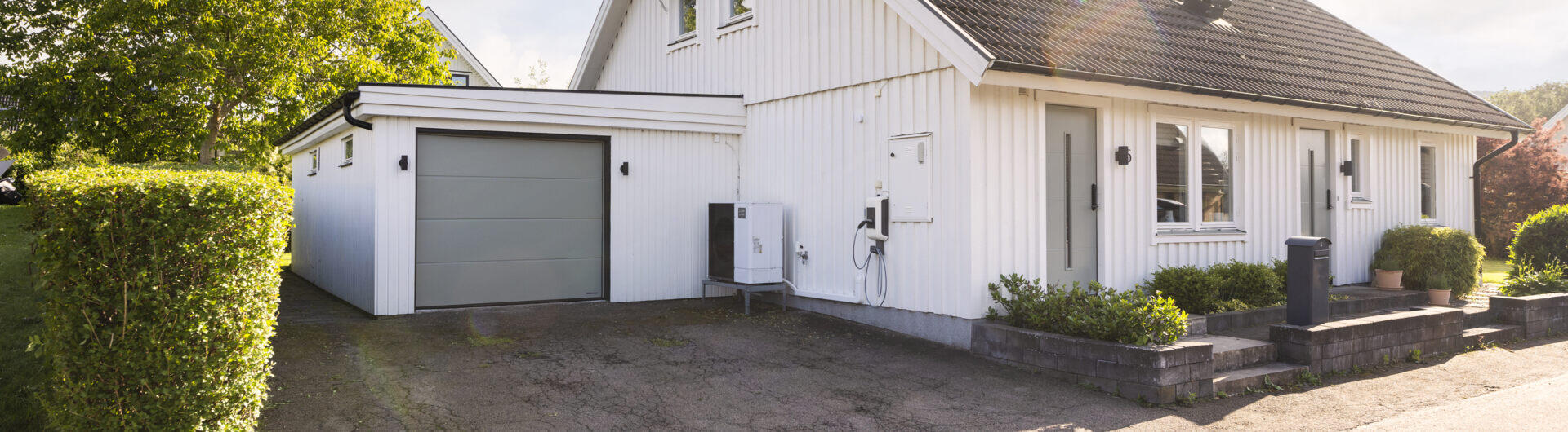 The family house with the new garage door in the same colour as the front door.