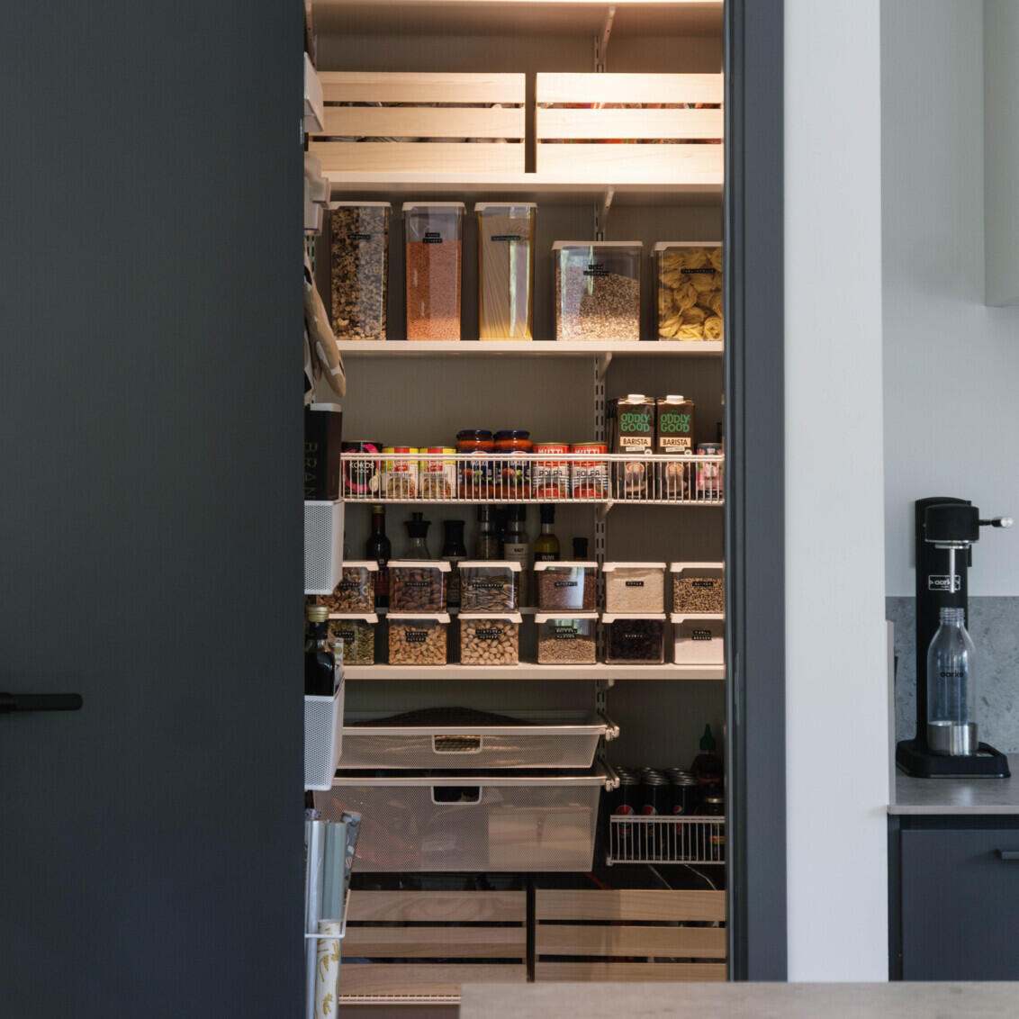 Elfa cabinetry seen through doorway with illuminated shelves